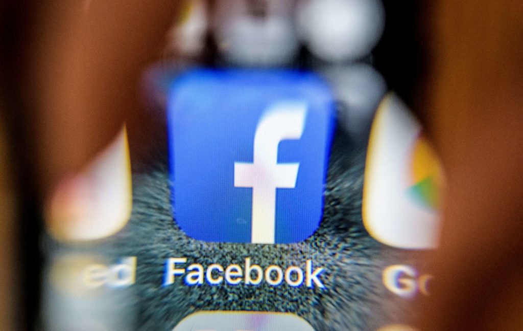 An illustration picture taken through a magnifying glass on March 28, 2018 in Moscow shows the icon for the social networking app Facebook on a smart phone screen. Facebook said on March 28, 2018 it would overhaul its privacy settings tools to put users "more in control" of their information on the social media website. The updates include improving ease of access to Facebook's user settings, a privacy shortcuts menu and tools to search for, download and delete personal data stored by Facebook. / AFP PHOTO / Mladen ANTONOV        (Photo credit should read MLADEN ANTONOV/AFP/Getty Images)